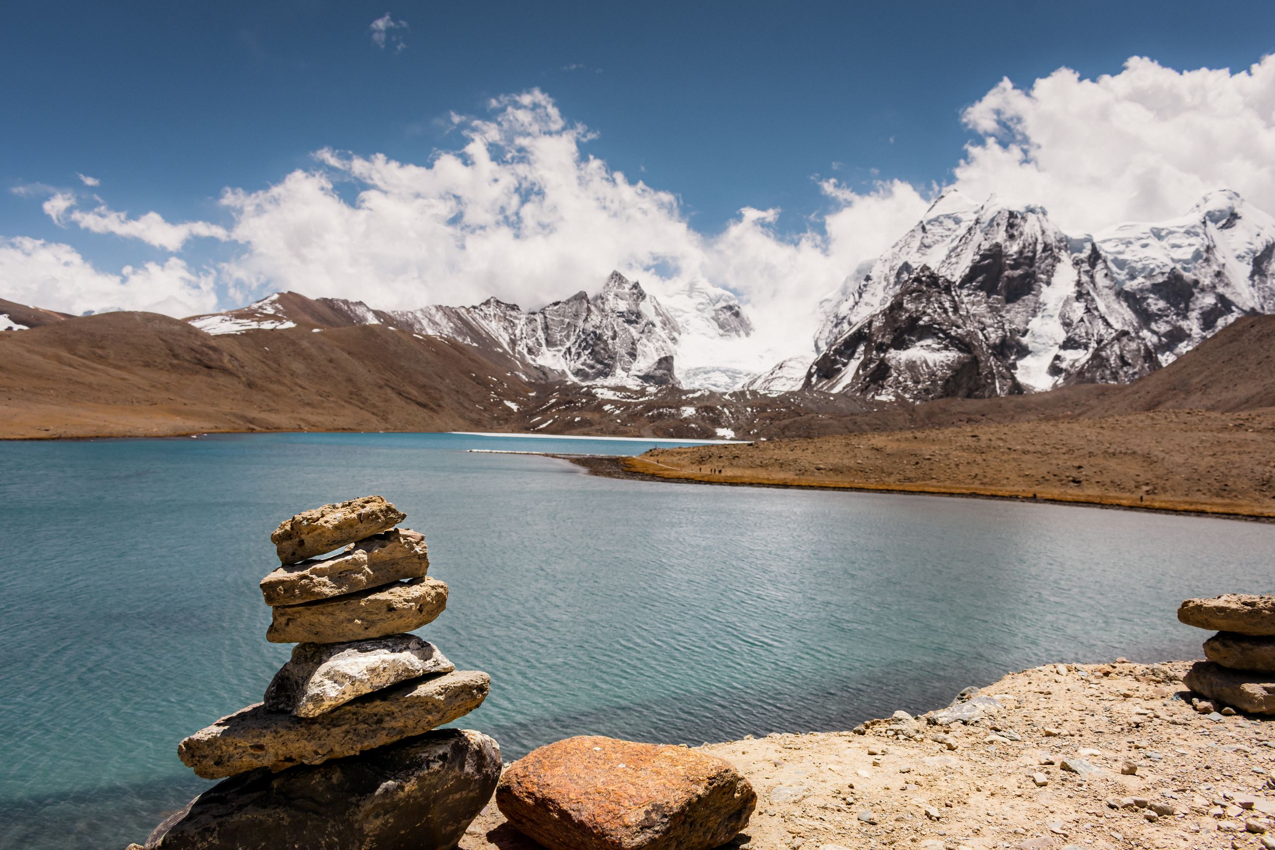 Breathtaking view of Gurudongmar Lake with mountainous backdrop in the Himalayas.